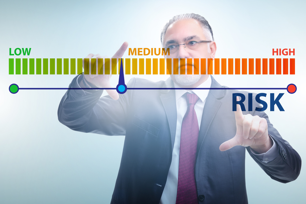 man assesing the level of risk on low to high digital scale for credit card payments