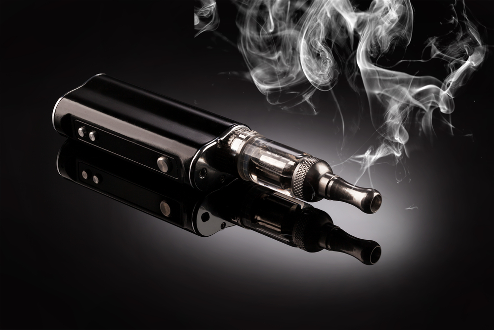  Electronic cigarette vape on dark background with smoke to symbolize Ecig Merchant Accounts