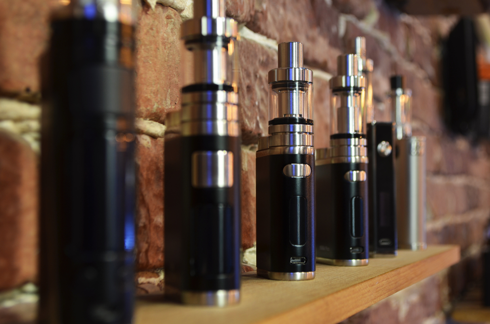 close-up of electronic cigarettes in exhibitions over a wooden stand to show Ecig Merchant Accounts