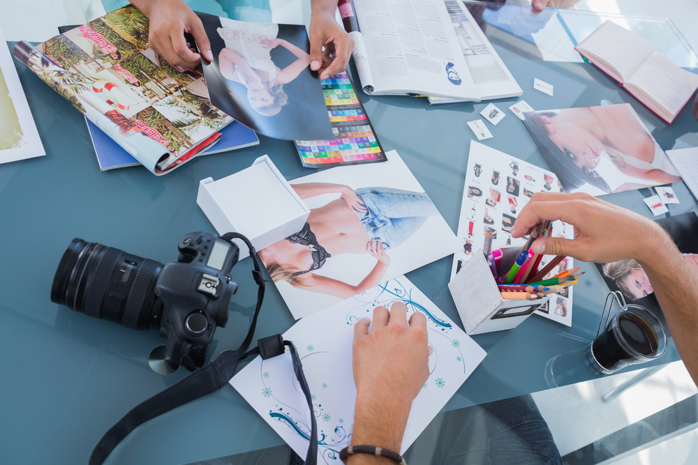 High angle closeup of creative business team brainstorming design ideas over table to represent Merchant Account