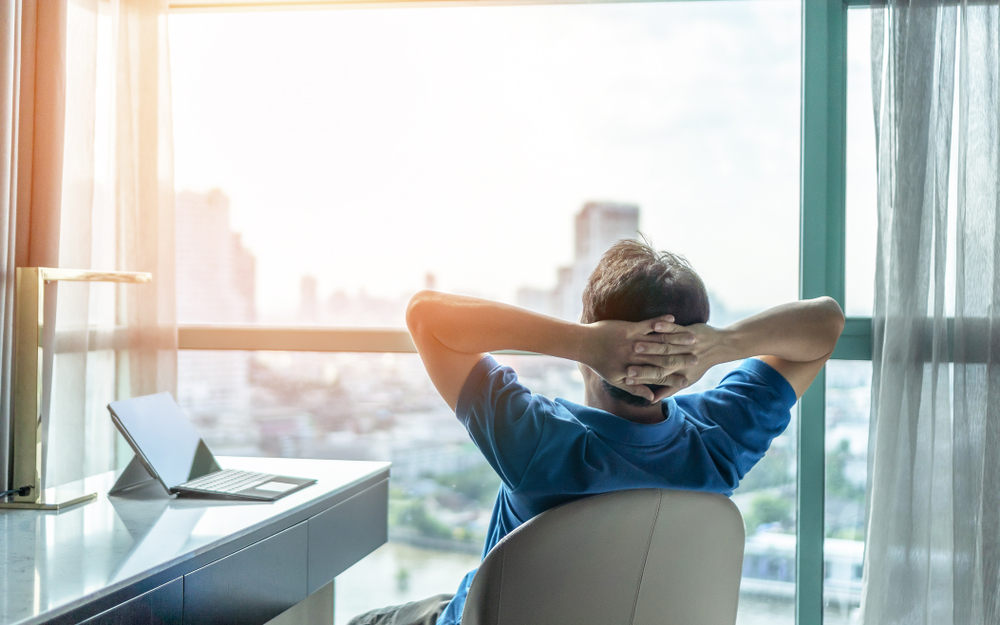 Rear view close up relaxed businessman stretching in comfortable office chair after work done symbolized Bad Credit Merchant Account