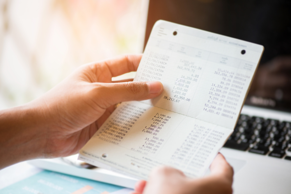 close up of book bank with blur rows coins for finance and banking concept to represent Payment Processing Merchant Account