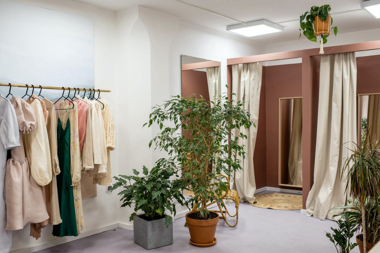 A retail storefront with clothes and plants that uses a retail merchant account for their business.