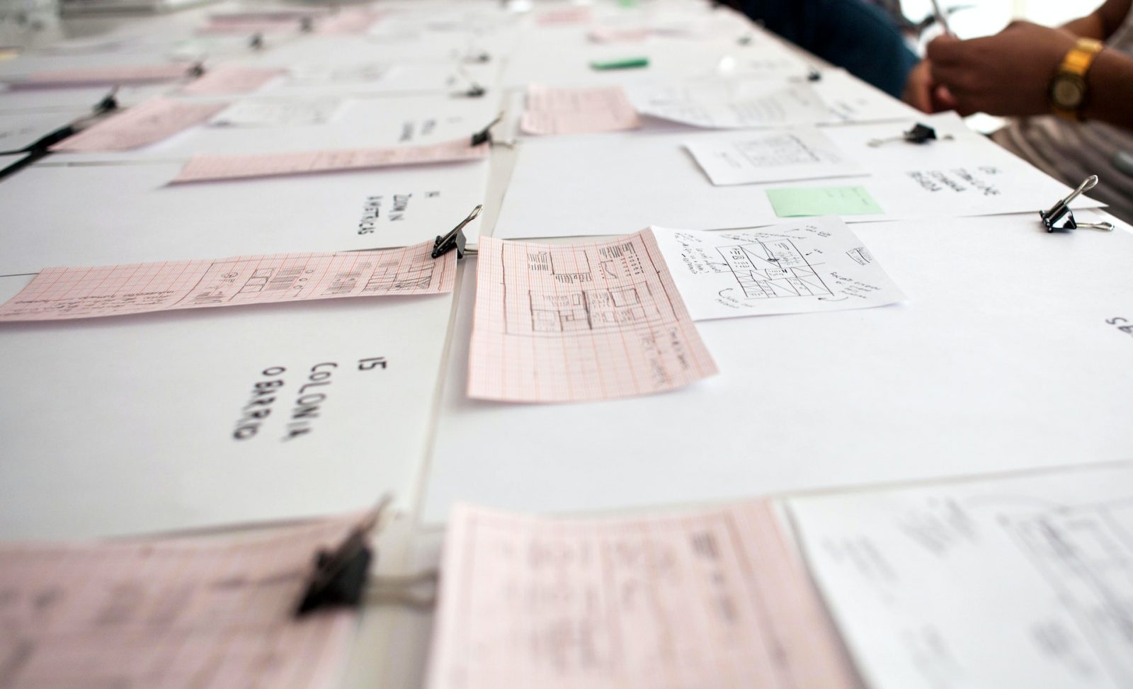 Several checks laid out on a table to symbolize check payment processing companies