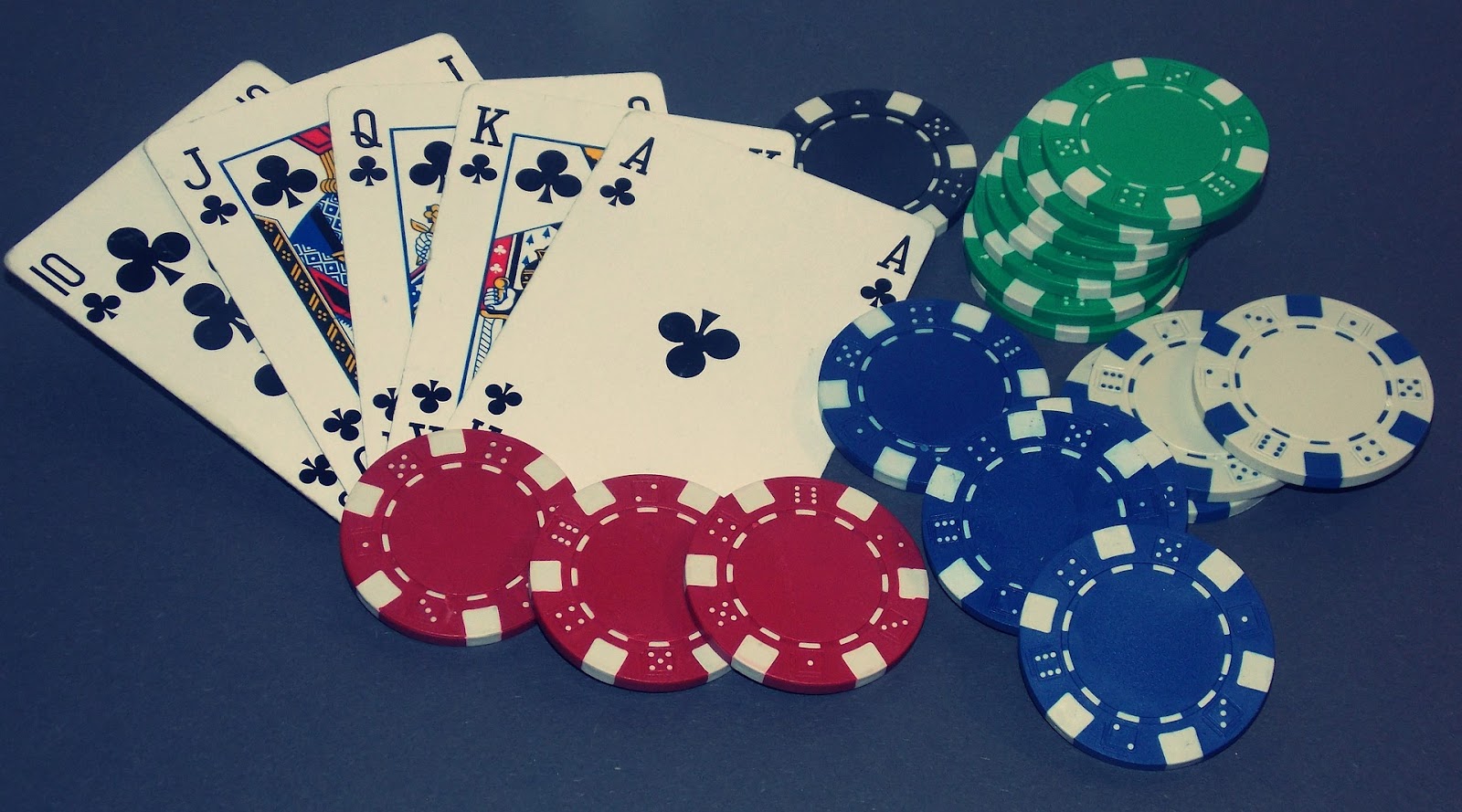 Cards laid out with poker chips to symbolize benefits of using a gaming payment processor