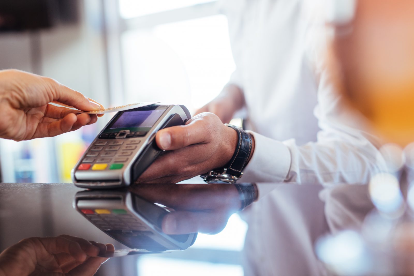 A customer making a payment with a card at a terminal to the merchant’s merchant account.