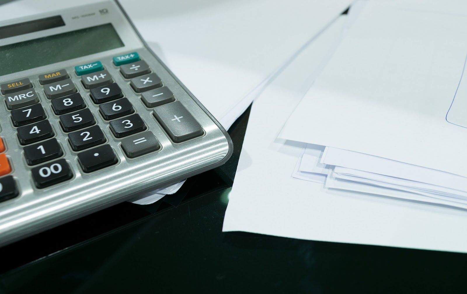 Papers and calculator to symbolize how to get a continuity subscription merchant account