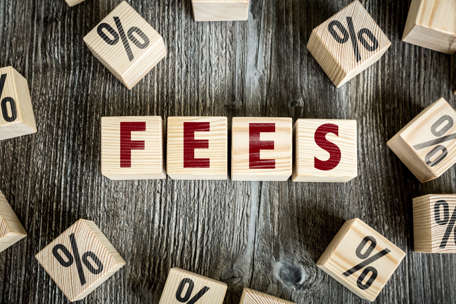 Blocks that spell out the word fees surrounded by other blocks with percentage signs referencing the fees that are charged for merchant accounts.