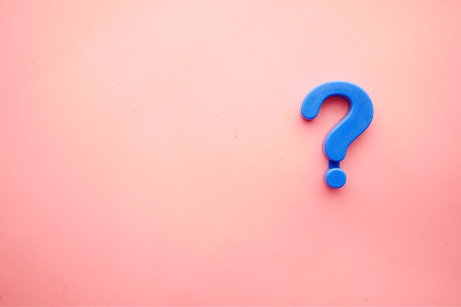 Blue question mark on pink background to symbolize most commonly asked questions about how to open a high risk merchant account
