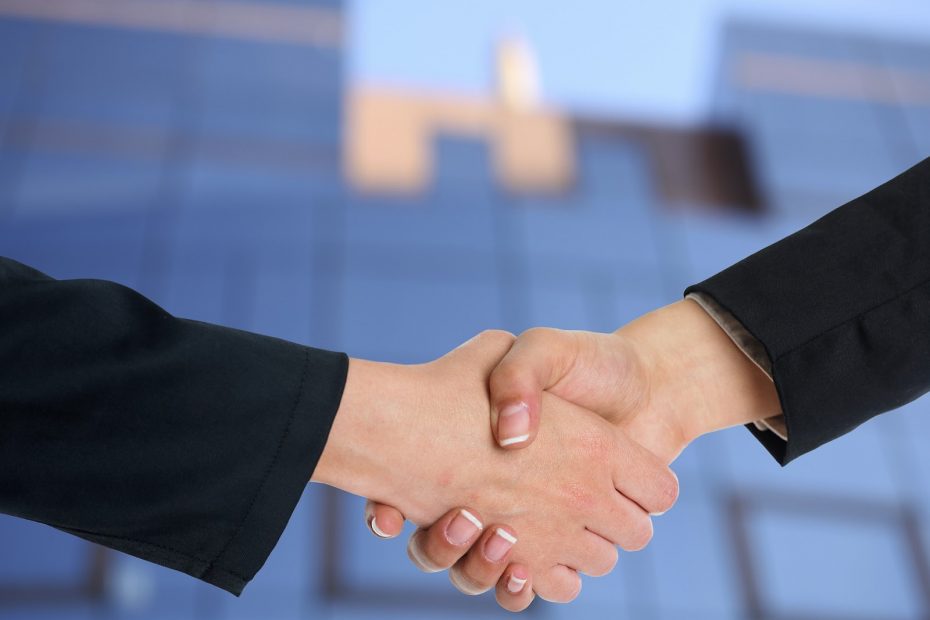 Handshake to symbolize offering consumer financing for small business as a deal