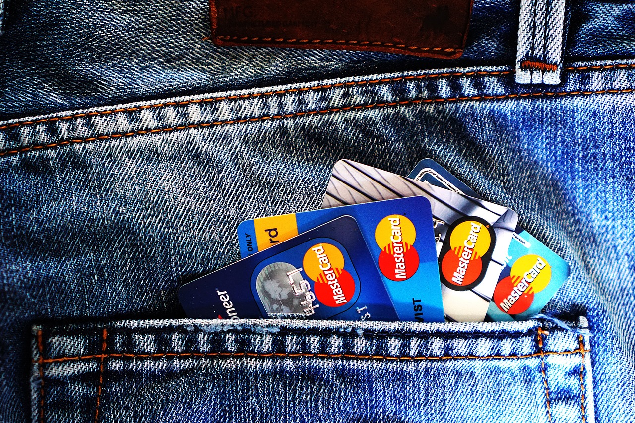 Several bank cards sticking out of a back pocket.