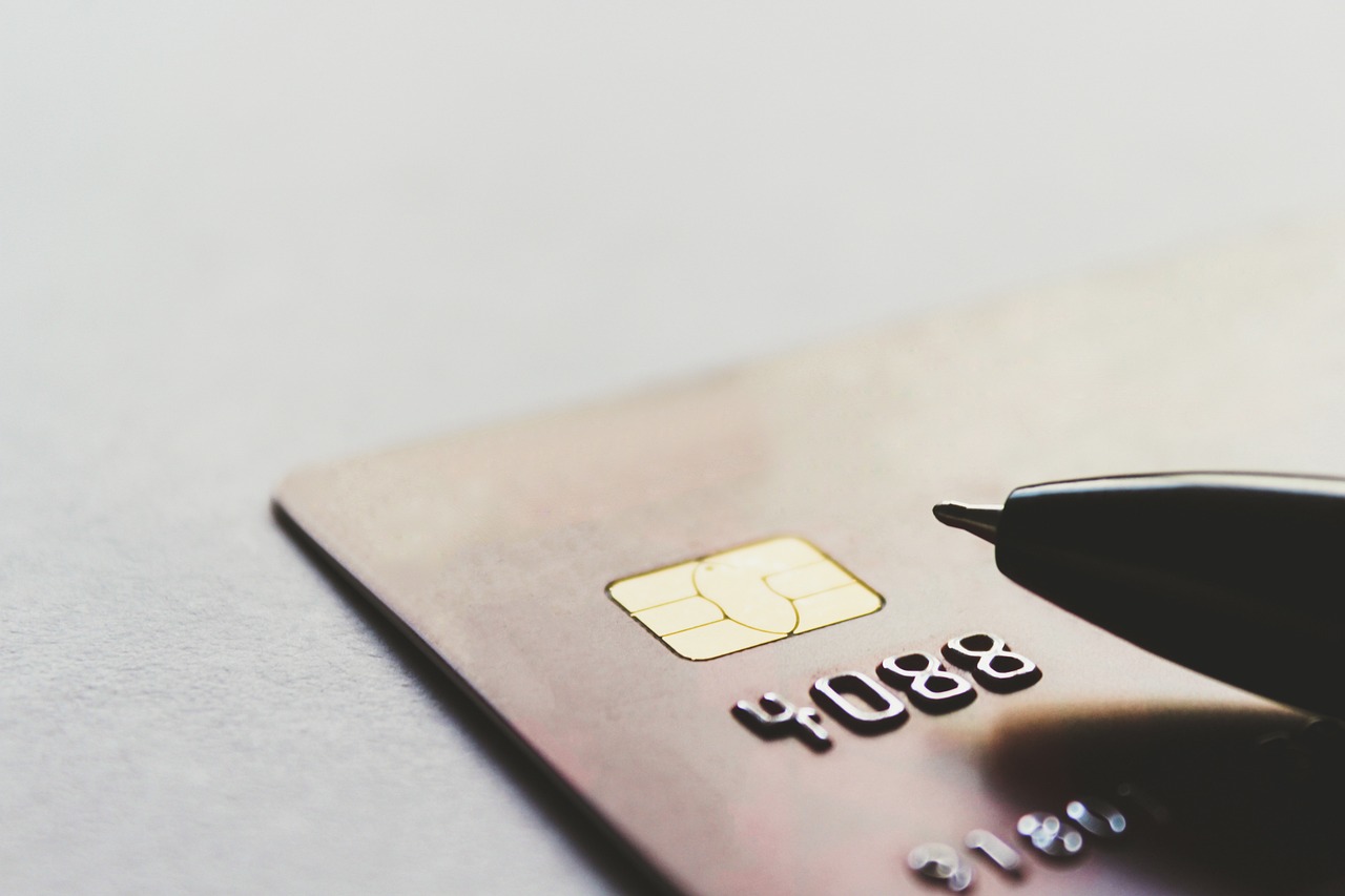 A close-up of a bank card with a pen resting on it.