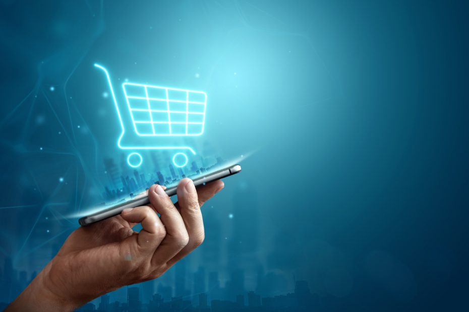 A smartphone with a digital shopping cart coming out of it symbolizes e-commerce.