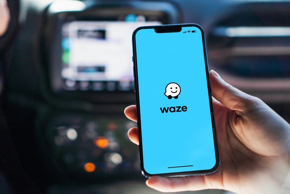 Written Waze on mobile screen representing opening waze app