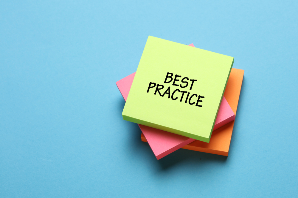 A stack of three packs of Post-it notes with the one on top having best practice written on it surrounded by a blue background.