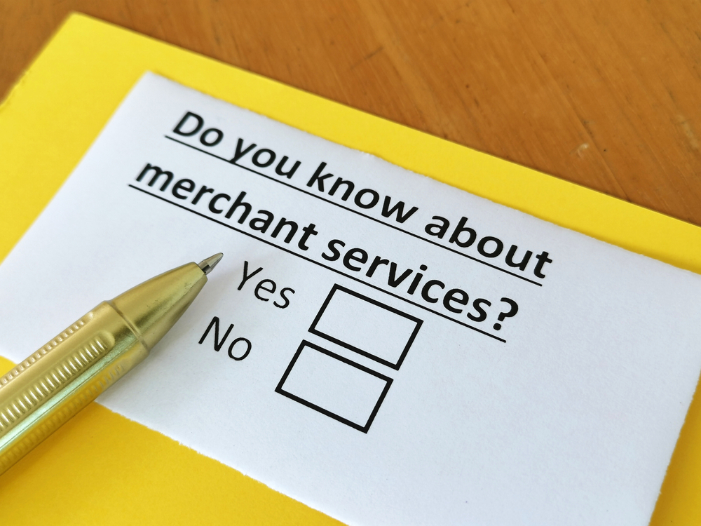 A paper that says “Do you know about merchant services?” with two boxes below, one with the word “yes” next to it and one with the word “no” next to it.